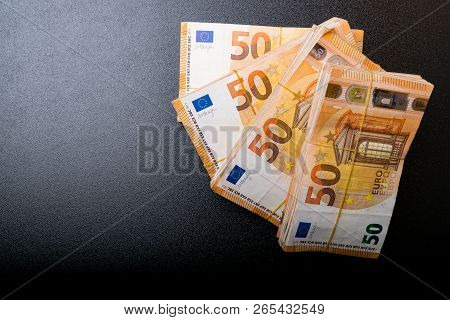 Pile Of 50 Real Euro Notes 50-euro Banknotes Under Rubber Band Isolated On Black. About 20000 Euros 