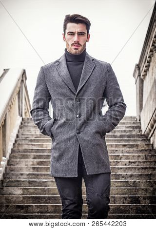 Handsome Bearded Young Man Outdoor In Winter Fashion, Wearing Black Turtleneck Sweater And Woolen Bl