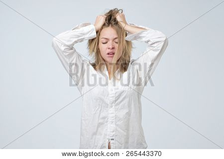 Sleepy Or Drowsy Young Girl Wearing White Shirt Of Her Boyfriend, Isolated On White.