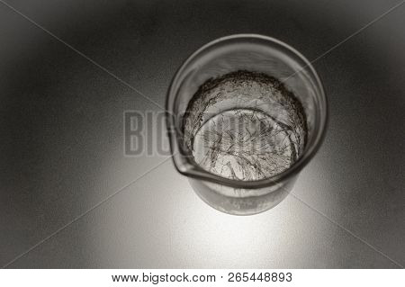 Chemical Glass With Crystals Of Salicylic Acid On A Matte Glass