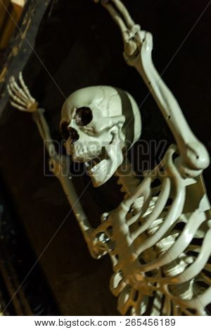 Screaming Captive Skeleton Hangs From Wall In Pain. Intentional Motion Blur To Convey Movement