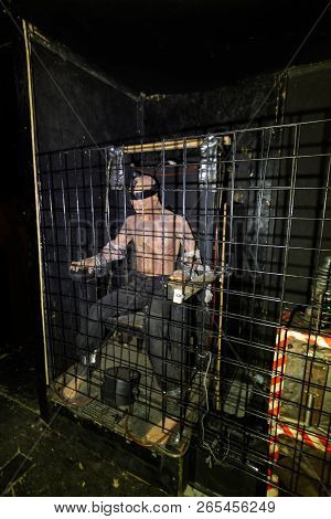 Tortured Man Strapped In Electric Chair In A Cage