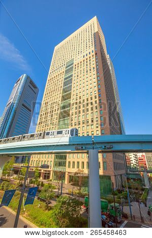 Tokyo, Japan - April 20, 2017: Vertical View Of Elevated Monorail Train To Daiba, Passing Between Sh