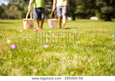 Easter Eggs Hunt. Blurred Silhouettes Of Children With Baskets In Hands. The Concept Of Family Fun A
