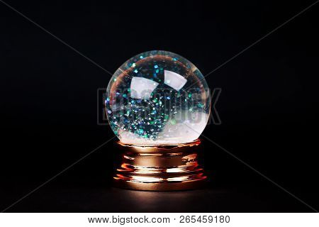 Beautiful Snow Ball With Snowfall Inside Over Black Background.