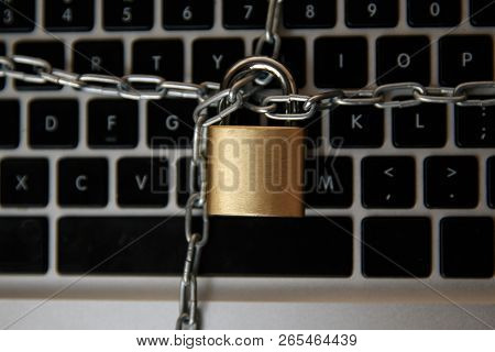 Cyber Safety Concept, Locked And Key On Laptop Computer Keyboard , Key To Unlock Before Green Backgr