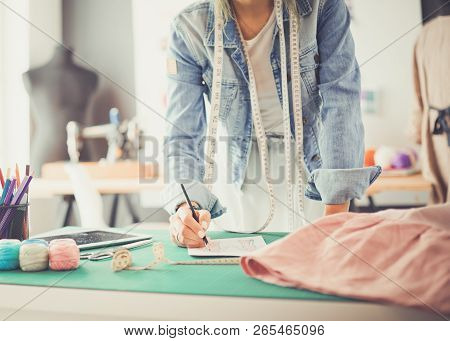 Fashion Designer Woman Working On Her Designs In The Studio