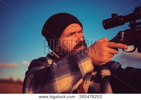 Hunting Is The Practice Of Killing Or Trapping Animals. Hunter With Shotgun Gun On Hunt