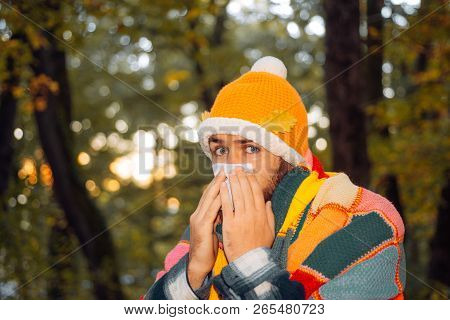 Healthcare And Medicine Concept - Ill Man With Paper Tissue In Autumn Park. Mature Man In Jacket Suf