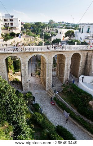 Polignano A Mare, Italy - July 6 2018: People On The Ponte Lama Monachile Bridge, Adriatic Sea, Apul