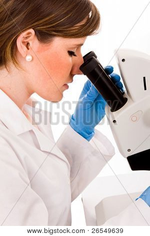close-up of a young medical student looking through microscope in laboratory