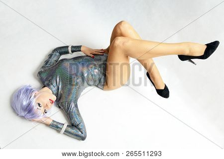 Young Girl, Dancer Wearing Costume. Female Model With Special Metallic Costume And Light Purple Wig.