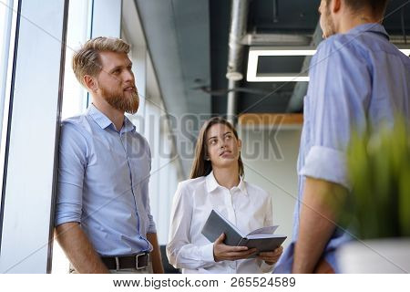 Group Of Young Modern People In Smart Casual Wear Having A Brainstorm Meeting While Standing In The 