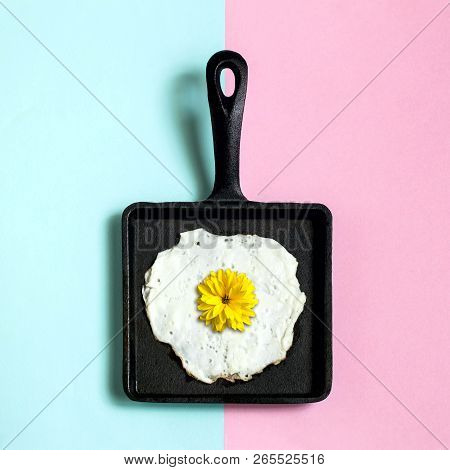 Square Cast-iron Frying Pan With Fried Eggs, Flower Of Rudbeckia Instead Of Yolk. Artificial Objects
