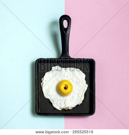 Square Cast-iron Frying Pan With Fried Eggs, Ball Of Yarn Instead Of Yolk. Artificial Objects That M