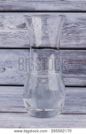Clear Glass Vase With Water On Wooden Background. Water In Transparent Glass Vase On Vintage Wooden 