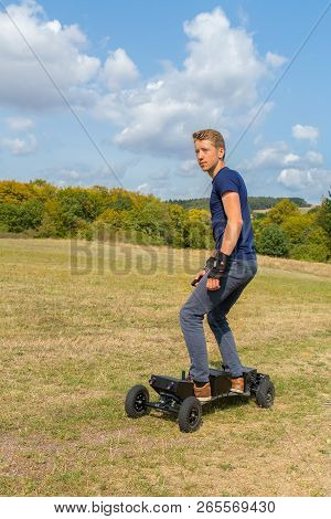 Young European Man Rides Electrical Mountainboard Offroad