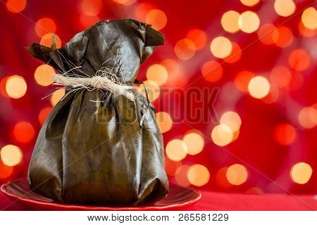 Traditional Colombian Tamale As Made On Tolima Region Over A Christmas Red Background