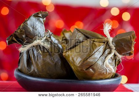 Traditional Colombian Tamale As Made On Tolima Region Over A Christmas Red Background