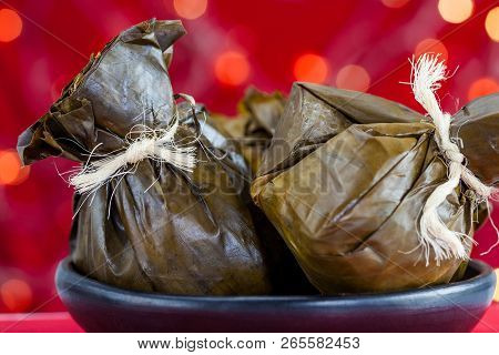 Traditional Colombian Tamale As Made On Tolima Region Over A Christmas Red Background