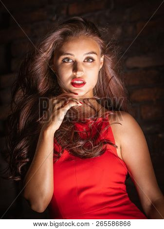 Curly Woman In Red Dress At The Night Club