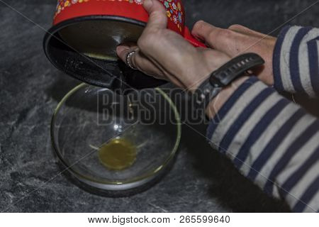 Cooking Of Marijuana Green Butter In Hot Water In Kitchen