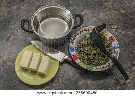 Cooking Of Marijuana Green Butter In Hot Water In Kitchen