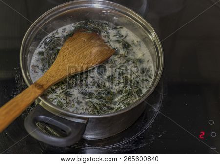 Cooking Of Marijuana Green Butter In Hot Water In Kitchen