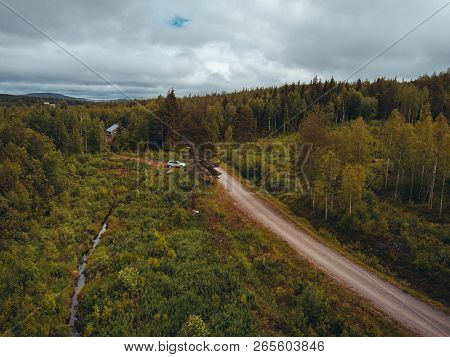 Car Leaving A House In The Forest In Northern Finland, Seen From The Sky
