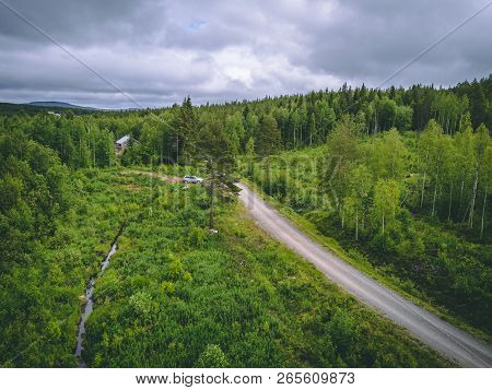 Car Leaving A House In The Forest In Northern Finland, Seen From The Sky