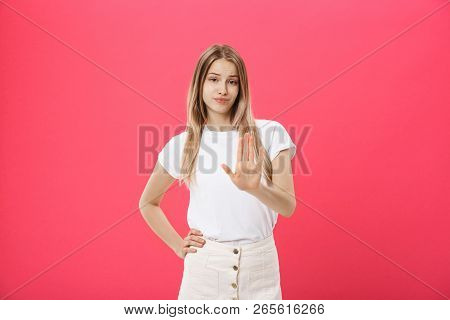 Displeased Female Model With Freckled Skin, Raises Eyebrows And Frowns Face, Makes Refusal Gesture, 