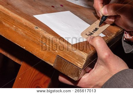 Woman Writing A Text For A Date Night Jar Messages On Wood. Text At A Hens Party For The Bride. Hori