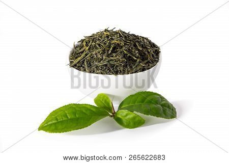Green Sencha Tea In White Cup With Tealeaves In Front Isolated On White Background.