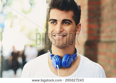 Young Man Listening Something. Outdoors.