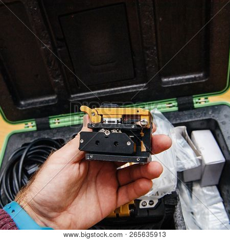 Technician Side View At High-precision Optical Fiber Cleaver For Cutting Optical Fiber Very Precisel