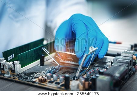Closeup Of Computer Technician Researcher Is Holding Cpu's Computer For Examination Before Replacing