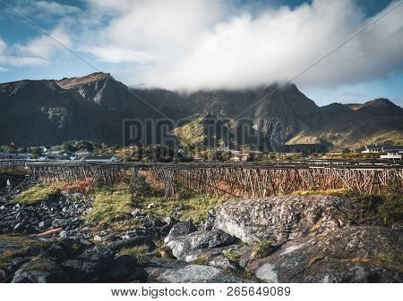 Rainbow Ofer Red Houses Rorbuer Of Reine In Lofoten, Norway With Red Rorbu Houses, Clouds, Rainy Blu