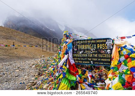 Information Sign And Prayer Flags On Thorang-la Pass, Annapurna Conservation Area, Nepal