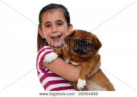 Beautiful girl holding a small pekingese dog on a white background