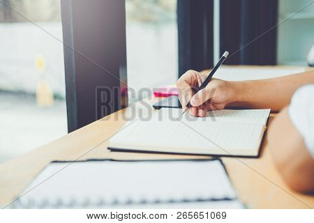High School Or College Students Studying And Reading Together In Library