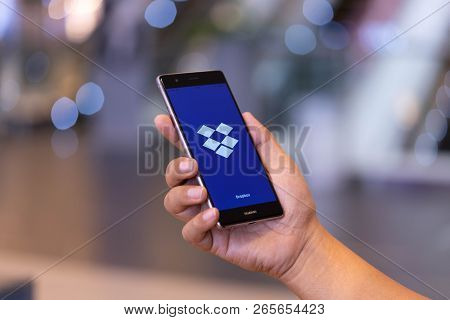 Chiang Mai, Thailand - Oct. 28,2018: Man Holding Huawei With Dropbox On Screen. Dropbox Is A Service