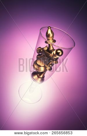 Chess Pieces In Wine Glass With Red Background