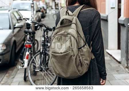 Tourist With A Backpack Is Looking For Booked Online Accommodation In An Unfamiliar City. Or A Stude