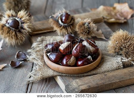 Roasted Chestnuts  Rustic Wooden Board Background, Selective Focus, Roasted Chestnuts . Roasted Ches