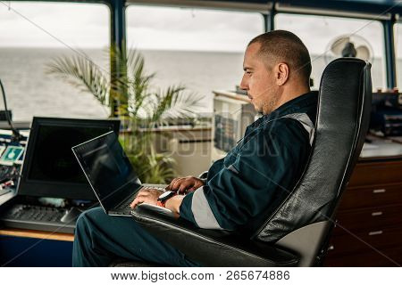 Marine Navigational Officer Is Using Laptop Or Notebook At Sea