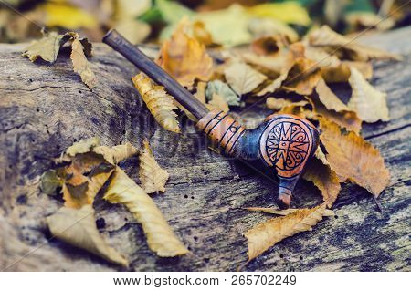 A Tube For Smoking, Made Of Clay, Using Trypillian Ornament. Autumn Photo