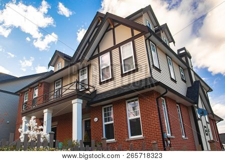 Row Of Typical English Terraced Houses. Red Brick Homes Side By Side.