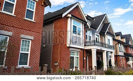 Red Brick Homes Side By Side. Row Of Typical English Terraced Houses, Townhomes.