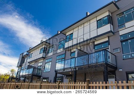 External Facade Of A Row Of Colorful Modern Urban Townhouses. Brand New Houses Just After Constructi