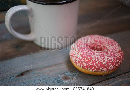Fresh Donut With Cup Of Coffee On The Wooden Table